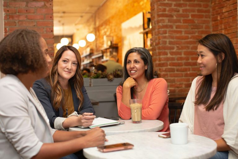 Female colleagues sat around a table